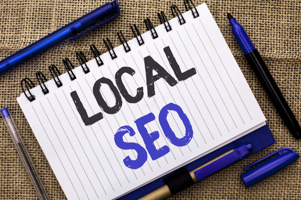 Conceptual hand writing showing Local Seo. Business photo showcasing Search Engine Optimization Strategy Optimize Local Find Keywords written on Notebook Book on jute background Pens next to it.